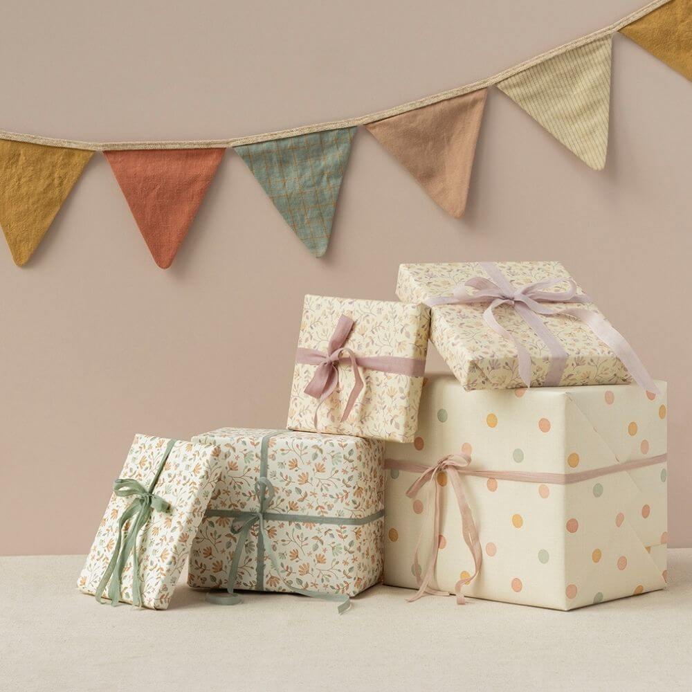 A group of wrapped presents using Maileg wrapping paper
