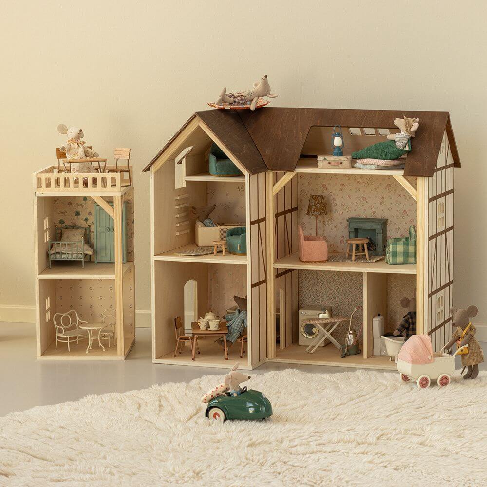 Maileg Wooden house with interior details and toys on a soft surface