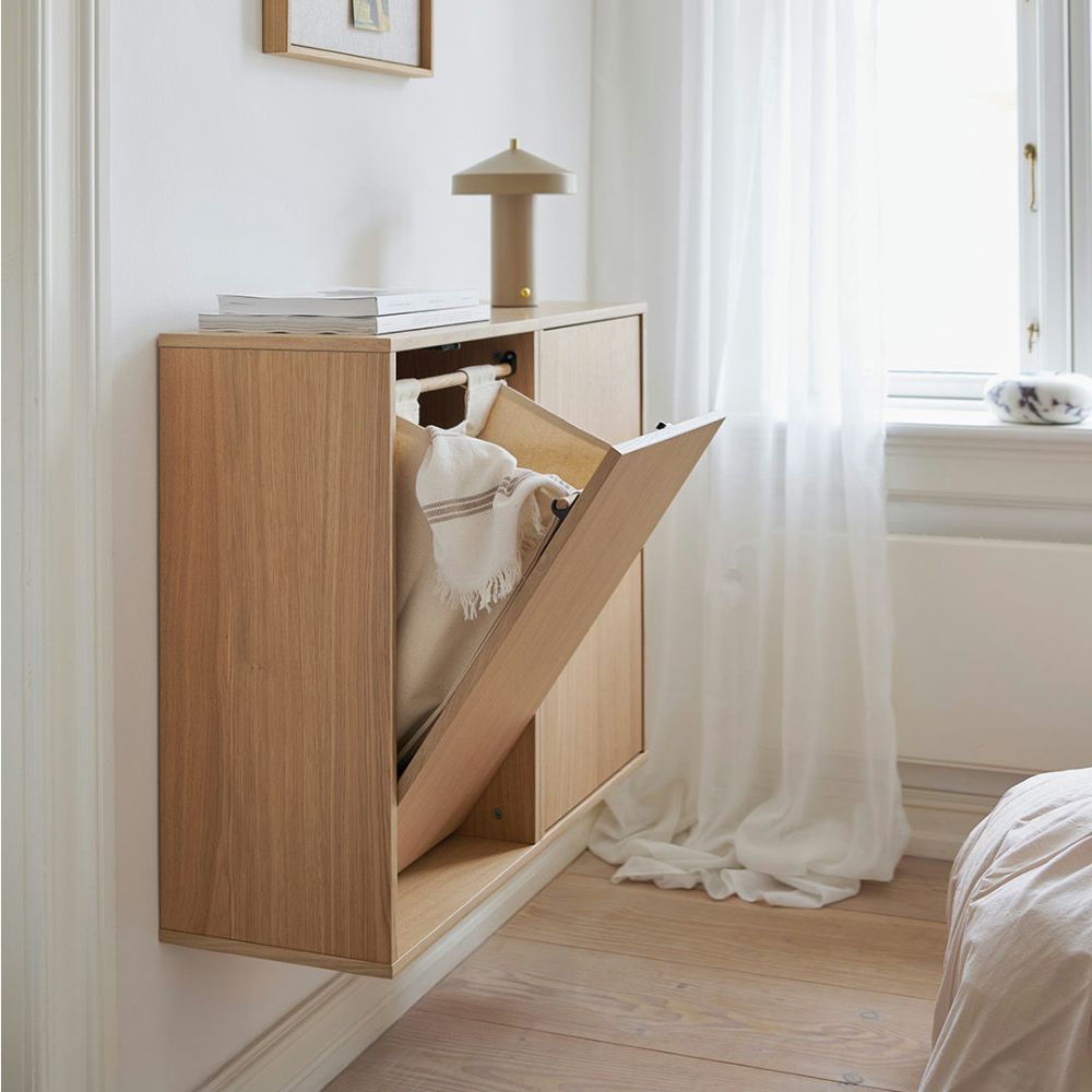 Wooden cabinet with a pull-out bed in a bedroom setting